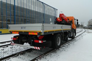 The power transmission on the driven rail wheels is hydrostatic. The vehicle is driven by means of 4-wheel single unit hydrostatic rail gear suspended on the base vehicle frame between the front and rear road axles. The movement of mechanisms is hydraulic and is controlled electrically from the driver's cab and from the side control panels located on the vehicle.